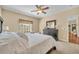 Cozy main bedroom featuring carpet, neutral walls, a queen bed, and dark wood furnishings at 789 Kangaroo Ct, Deltona, FL 32738