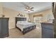 Relaxing main bedroom with a large bed, carpet, dark wood furniture, and a sunlit window at 789 Kangaroo Ct, Deltona, FL 32738