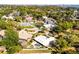 Expansive aerial view of a home with a pool and tennis court in a lush, green neighborhood at 8905 South Bay Dr, Orlando, FL 32819