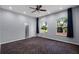 Large room featuring two large windows and blue curtains at 8905 South Bay Dr, Orlando, FL 32819