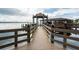 Wooden dock with gazebo leading to a covered boathouse on the water at 8905 South Bay Dr, Orlando, FL 32819