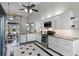 Modern kitchen with stainless steel appliances, white cabinets and tile flooring at 8905 South Bay Dr, Orlando, FL 32819