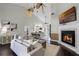 Open-concept living room with fireplace, ceiling fans, and view of the modern kitchen at 8905 South Bay Dr, Orlando, FL 32819