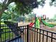 Colorful playground equipment with swings and slides in a fenced area at 8905 South Bay Dr, Orlando, FL 32819