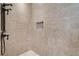 Tiled shower featuring bronze fixtures and a built-in toiletry shelf at 8905 South Bay Dr, Orlando, FL 32819