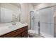 Bright bathroom featuring a wood vanity with white countertop and a glass-enclosed shower at 9732 Brown Burrow St, Orlando, FL 32829