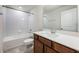 Bright bathroom features a shower-tub combo with modern white tile and a granite countertop vanity at 9732 Brown Burrow St, Orlando, FL 32829