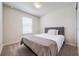 Cozy bedroom featuring plush carpeting, a queen bed with a padded headboard, and natural light at 9732 Brown Burrow St, Orlando, FL 32829