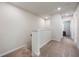 Upstairs hallway featuring neutral carpet, recessed lighting, and access to bedrooms and bathrooms at 9732 Brown Burrow St, Orlando, FL 32829