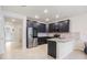 Modern kitchen featuring stainless steel appliances, sleek dark cabinetry, and light granite countertops at 9732 Brown Burrow St, Orlando, FL 32829