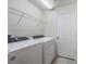 Functional laundry room with modern washer and dryer, and plenty of storage space at 9732 Brown Burrow St, Orlando, FL 32829