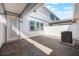 Private patio featuring stylish pavers, a white fence, and an outdoor air conditioning unit at 9732 Brown Burrow St, Orlando, FL 32829