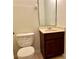 Cozy powder room with vanity, toilet, and humorous decorative wall art at 9843 Tivoli Villa Dr, Orlando, FL 32829