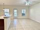 Bright living area with tiled floors, ceiling fan, and views of the neighborhood at 9843 Tivoli Villa Dr, Orlando, FL 32829