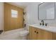 Bathroom featuring wood-look shower tile, modern vanity and fixtures, and neutral finishes at 10526 Fernando St, Orlando, FL 32825