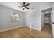 This bedroom features light-colored walls, wood floors, a ceiling fan, and a closet at 10526 Fernando St, Orlando, FL 32825