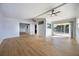 Spacious living room featuring wood flooring, sliding glass doors, ceiling fans, and recessed lighting at 10526 Fernando St, Orlando, FL 32825