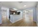 Bright, open-concept living space with wood flooring, seamlessly connected to the kitchen at 10526 Fernando St, Orlando, FL 32825