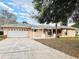 Charming single-story home featuring a two-car garage and a welcoming front entrance at 10631 Deergrass Ln, Orlando, FL 32821