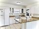 Well-lit kitchen featuring white cabinets, sleek countertops, and functional design elements at 10631 Deergrass Ln, Orlando, FL 32821