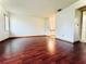 Hardwood floor in a spacious living room with natural light from the window at 10631 Deergrass Ln, Orlando, FL 32821