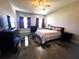 This bedroom features a ceiling fan, and modern floors at 10912 Smokey Ridge Ct, Clermont, FL 34711