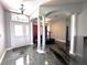 Bright foyer with epoxy floors, white columns, and decorative glass over front door at 10912 Smokey Ridge Ct, Clermont, FL 34711