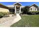 Inviting front yard with lush green lawn and a walkway leading to the front door, surrounded by well-maintained landscaping at 10912 Smokey Ridge Ct, Clermont, FL 34711