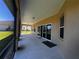 A covered patio with a sliding glass door provides a cool outdoor space at 10912 Smokey Ridge Ct, Clermont, FL 34711