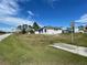 A single-story home on a sunny day, with a gray and white color scheme and a two-car garage at 1209 Atlantic Way, Kissimmee, FL 34759