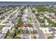 Aerial view of a home in a residential area, near a scenic lake and lush greenery at 134 Roberta Rd, Ormond Beach, FL 32176