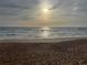 Beautiful beach scene with sun shining through cloudy sky at 134 Roberta Rd, Ormond Beach, FL 32176