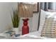 Bedroom detail highlighting the bedside table, lamp, and decorative plants at 134 Roberta Rd, Ormond Beach, FL 32176