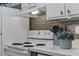 Bright kitchen with white cabinetry, stainless sink, and tile backsplash at 134 Roberta Rd, Ormond Beach, FL 32176