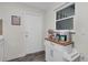 Bright breakfast nook with white cabinetry, a coffee station, and a door to the exterior at 134 Roberta Rd, Ormond Beach, FL 32176
