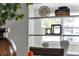 Close-up of decorative shelving with books, vases, and modern accents in the living area at 134 Roberta Rd, Ormond Beach, FL 32176