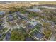 An aerial view of a neighborhood showcasing mature trees, lakes, and well-maintained landscaping at 1415 Crocus Ct, Longwood, FL 32750