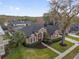 Aerial view of an elegant home with lush landscaping, a well-manicured lawn, and a private yard at 1415 Crocus Ct, Longwood, FL 32750