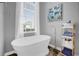 Bright bathroom featuring a modern freestanding tub near a window with natural light at 1415 Crocus Ct, Longwood, FL 32750