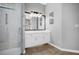 Bathroom featuring a glass shower, a large mirror, and ample counter space at 1415 Crocus Ct, Longwood, FL 32750