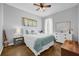 Inviting bedroom featuring hardwood floors, a ceiling fan, and soft, neutral tones for a cozy ambiance at 1415 Crocus Ct, Longwood, FL 32750