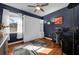 Stylish bedroom in dark-blue hues, featuring a murphy bed, work space, and natural light at 1415 Crocus Ct, Longwood, FL 32750