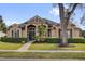 Charming single-story home featuring a manicured lawn, decorative shutters, and a welcoming entryway at 1415 Crocus Ct, Longwood, FL 32750