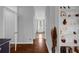 Hallway view leading to the bathroom, showcasing hardwood floors and built-in shelving at 1415 Crocus Ct, Longwood, FL 32750