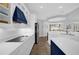 Modern kitchen with sleek countertops, stylish white cabinetry, and a navy blue vent hood at 1415 Crocus Ct, Longwood, FL 32750