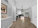 Living room showcasing tile floors, gray walls, grand piano, chandelier, and white china cabinet at 1415 Crocus Ct, Longwood, FL 32750