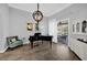 Living room showcasing tile floors, gray walls, grand piano, chandelier, and sliding doors to outside pool at 1415 Crocus Ct, Longwood, FL 32750