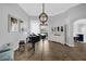 Living room showcasing tile floors, gray walls, grand piano, chandelier, and sliding doors to outside at 1415 Crocus Ct, Longwood, FL 32750