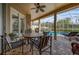 Inviting outdoor patio with ceiling fan, dining set, and views of the screened-in pool area at 1415 Crocus Ct, Longwood, FL 32750