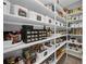 Organized pantry with white shelving, baskets, and labeled containers for efficient storage and convenience at 1415 Crocus Ct, Longwood, FL 32750